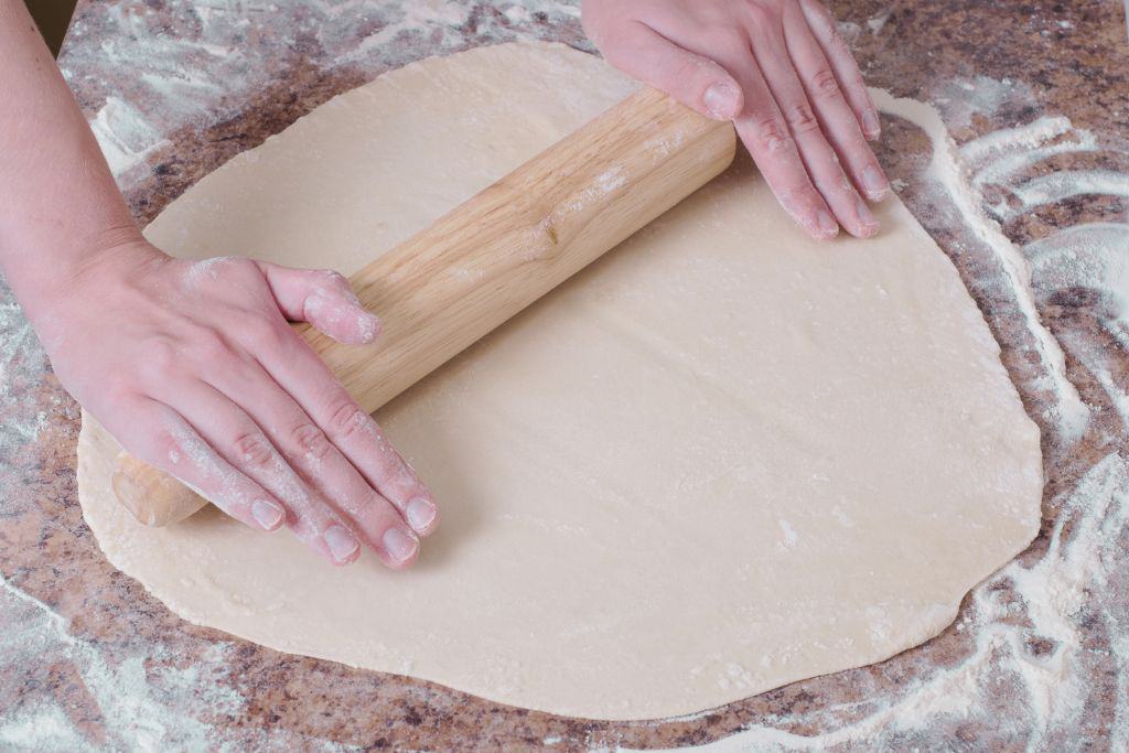 rolling out pasta dough - a skill that is taught in certain cooking classes in florence italy