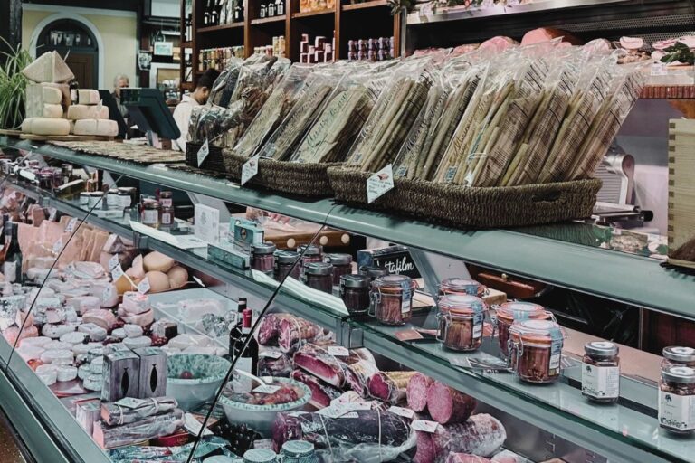 fresh bread, meats, and cheese displayed in central market, one of the most well-known markets in florence italy